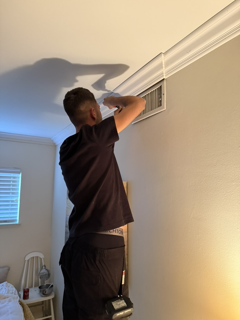 Air duct cleaning technician at ceiling vent in Santa Barbara home